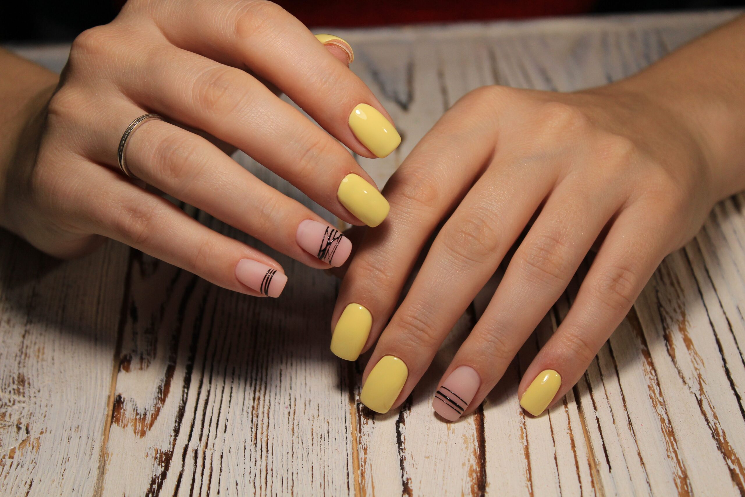 closeup-womans-hand-displaying-trendy-stylish-gel-manicure-design-salon-min